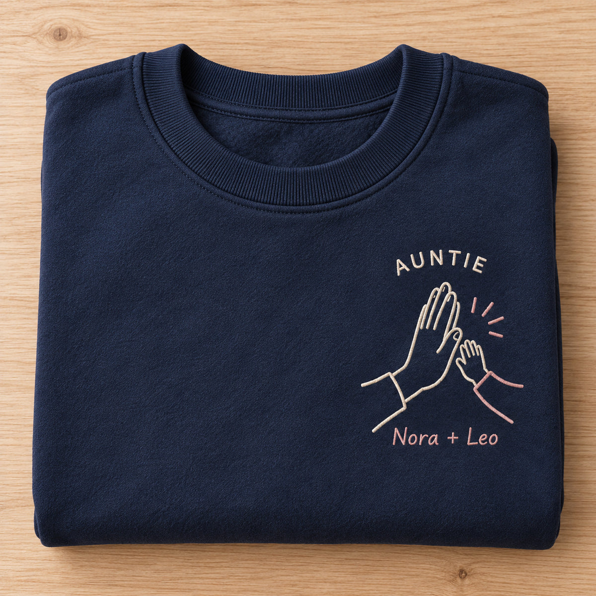 Little High Five personalized Auntie hands design; Navy sweatshirt mockup, personalization detail; sample text AUNTIE / Nora + Leo