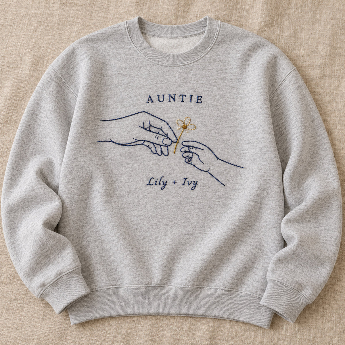 Gift of Daisies personalized Auntie hands design; Ash sweatshirt mockup, hero; sample text AUNTIE / Lily + Ivy