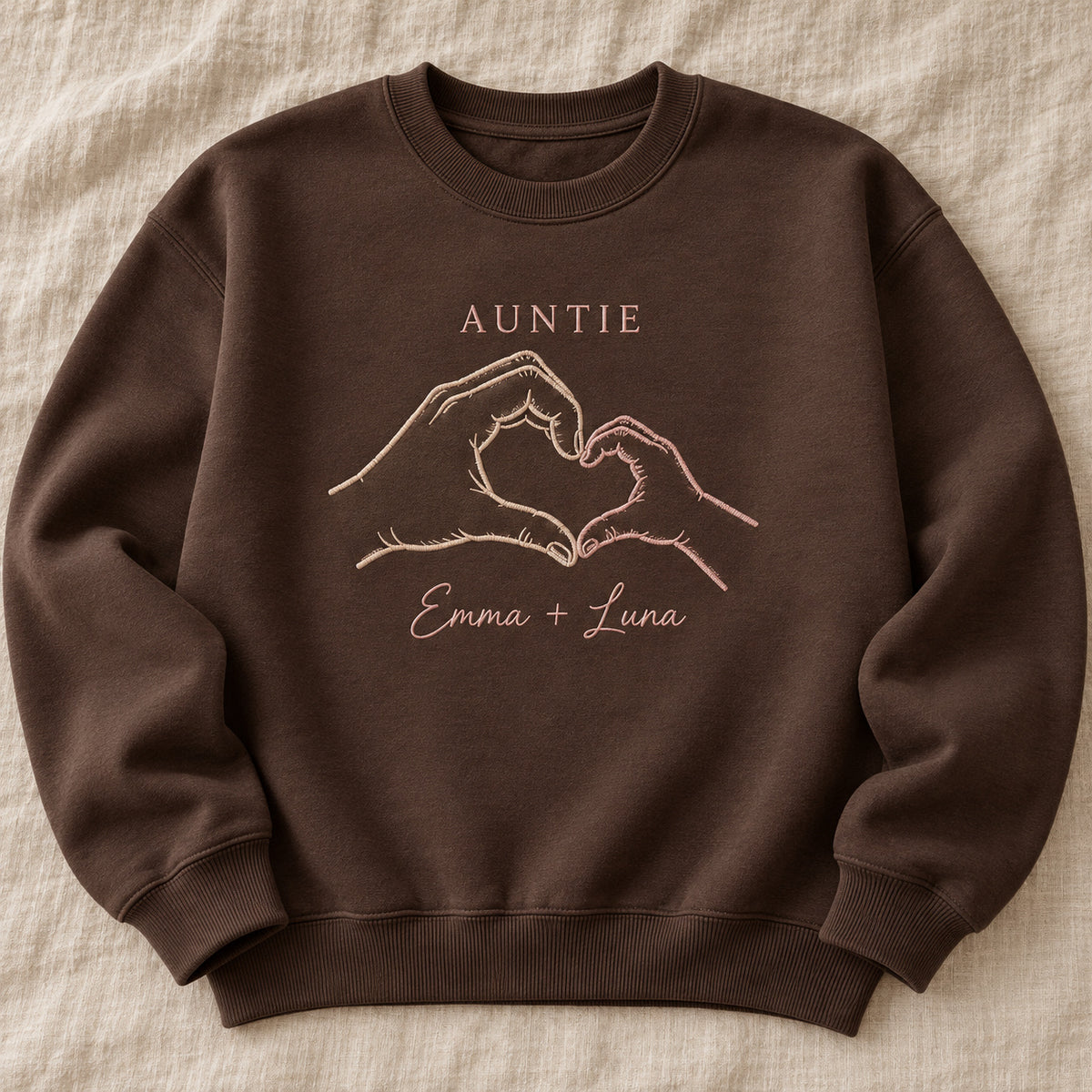 Tiny Hand Heart personalized Auntie hands design; Chocolate sweatshirt mockup, hero; sample text AUNTIE / Emma + Luna