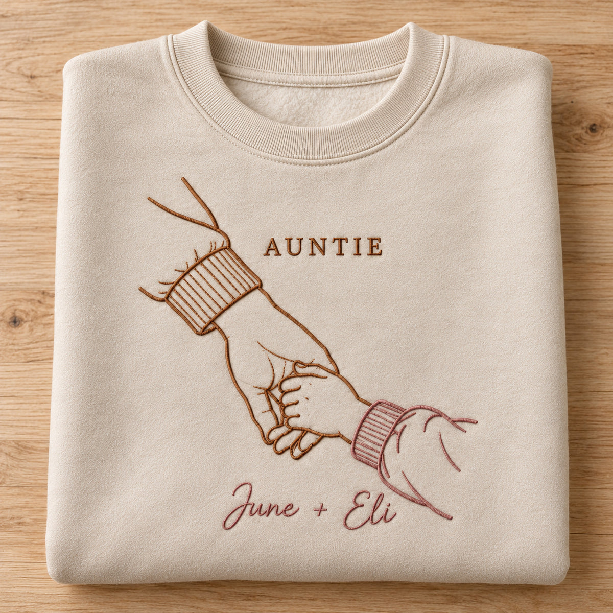 Walking Together personalized Auntie hands design; Beige sweatshirt mockup, personalization detail; sample text AUNTIE / June + Eli