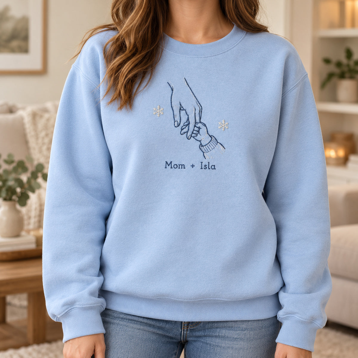 Holiday Home Hands personalized Christmas hands design; Light Blue sweatshirt mockup, lifestyle; sample text Mom + Isla