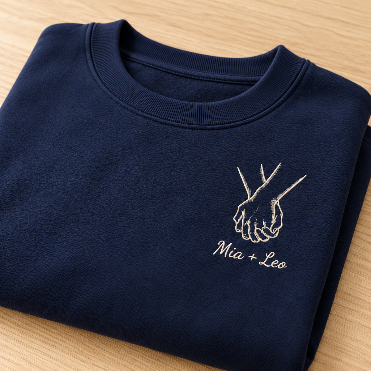Hand in Hand personalized Couples hands design; Navy sweatshirt mockup, personalization detail; sample text Mia + Leo