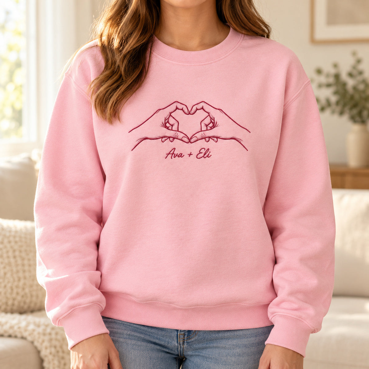 Heart Together personalized Couples hands design; Light Pink sweatshirt mockup, lifestyle; sample text Ava + Eli
