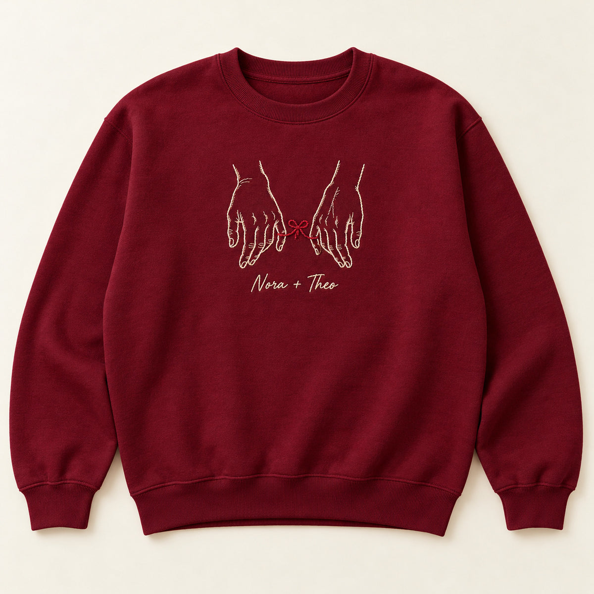Tied to You personalized Couples hands design; Maroon sweatshirt mockup, hero; sample text Nora + Theo