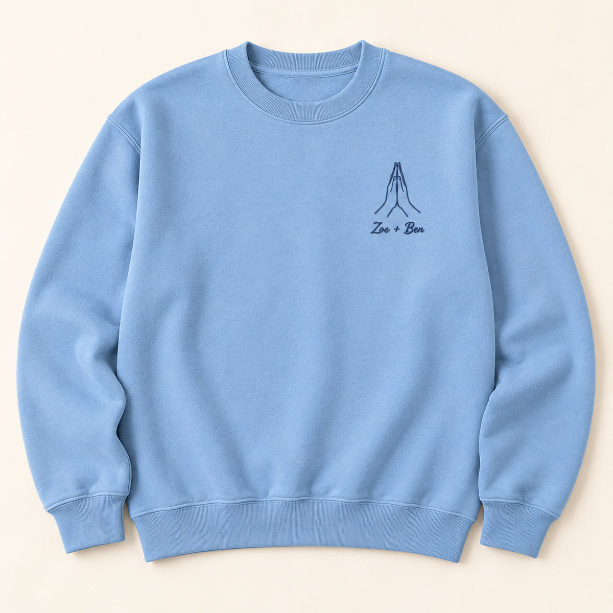 Your Warmth personalized Couples hands design; Carolina Blue sweatshirt mockup, hero; sample text Zoe + Ben