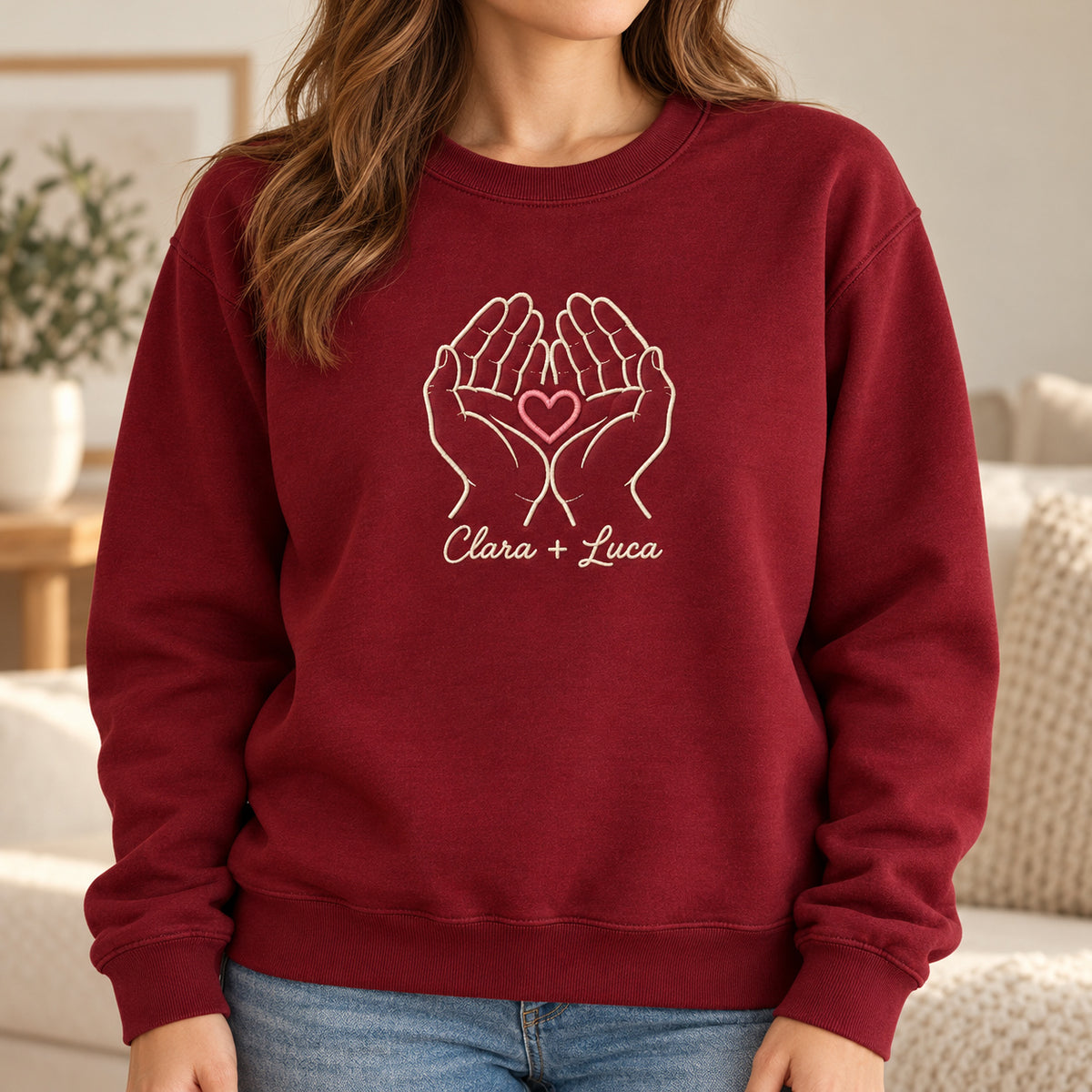 Holding Us personalized Couples hands design; Maroon sweatshirt mockup, lifestyle; sample text Clara + Luca