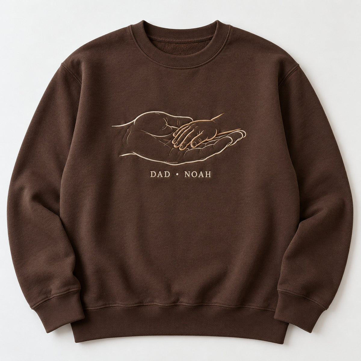 Safe In My Palm personalized Dad hands design; Chocolate sweatshirt mockup, hero; sample text DAD • NOAH