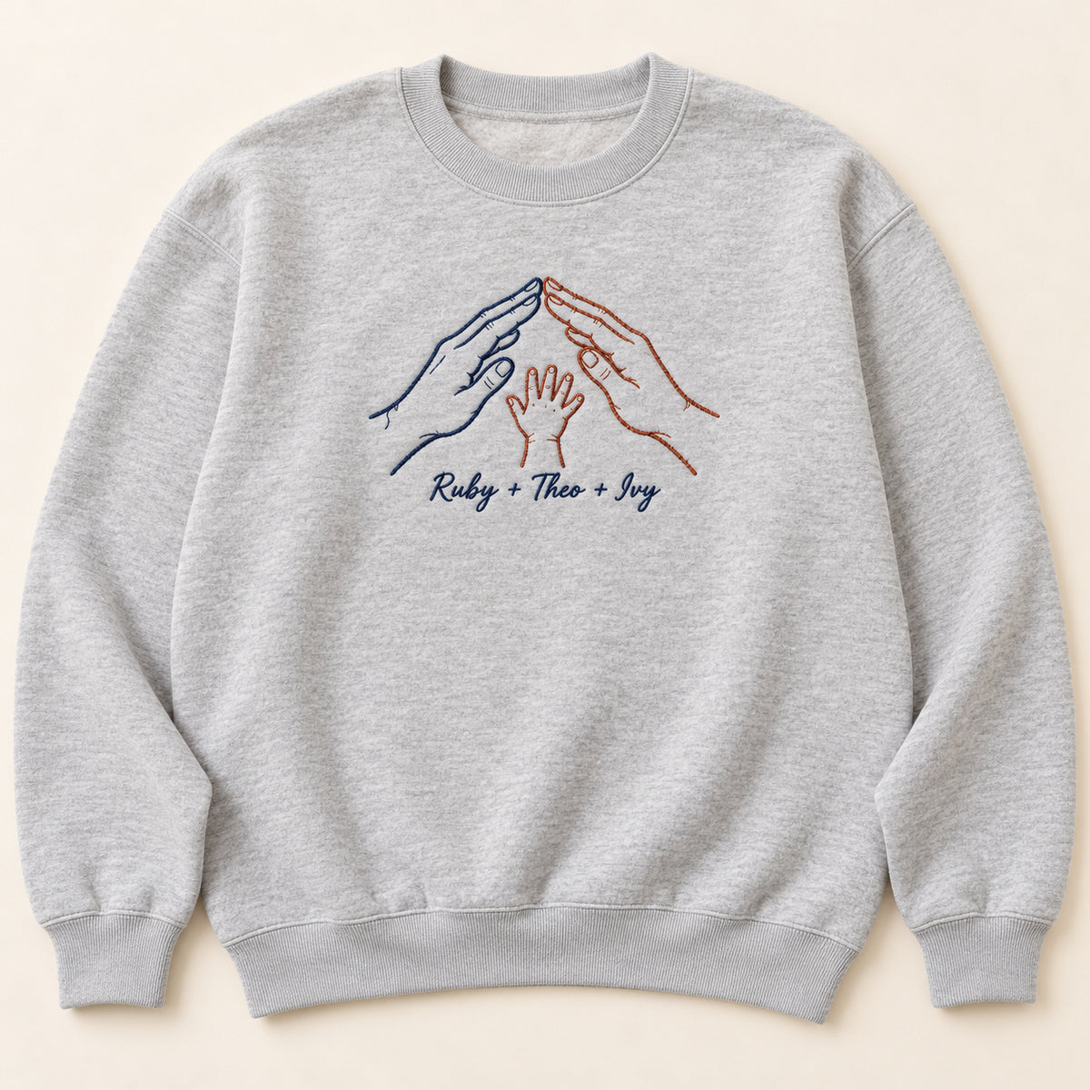 Home in Our Hands personalized Family hands design; Ash sweatshirt mockup, hero; sample text Ruby + Theo + Ivy