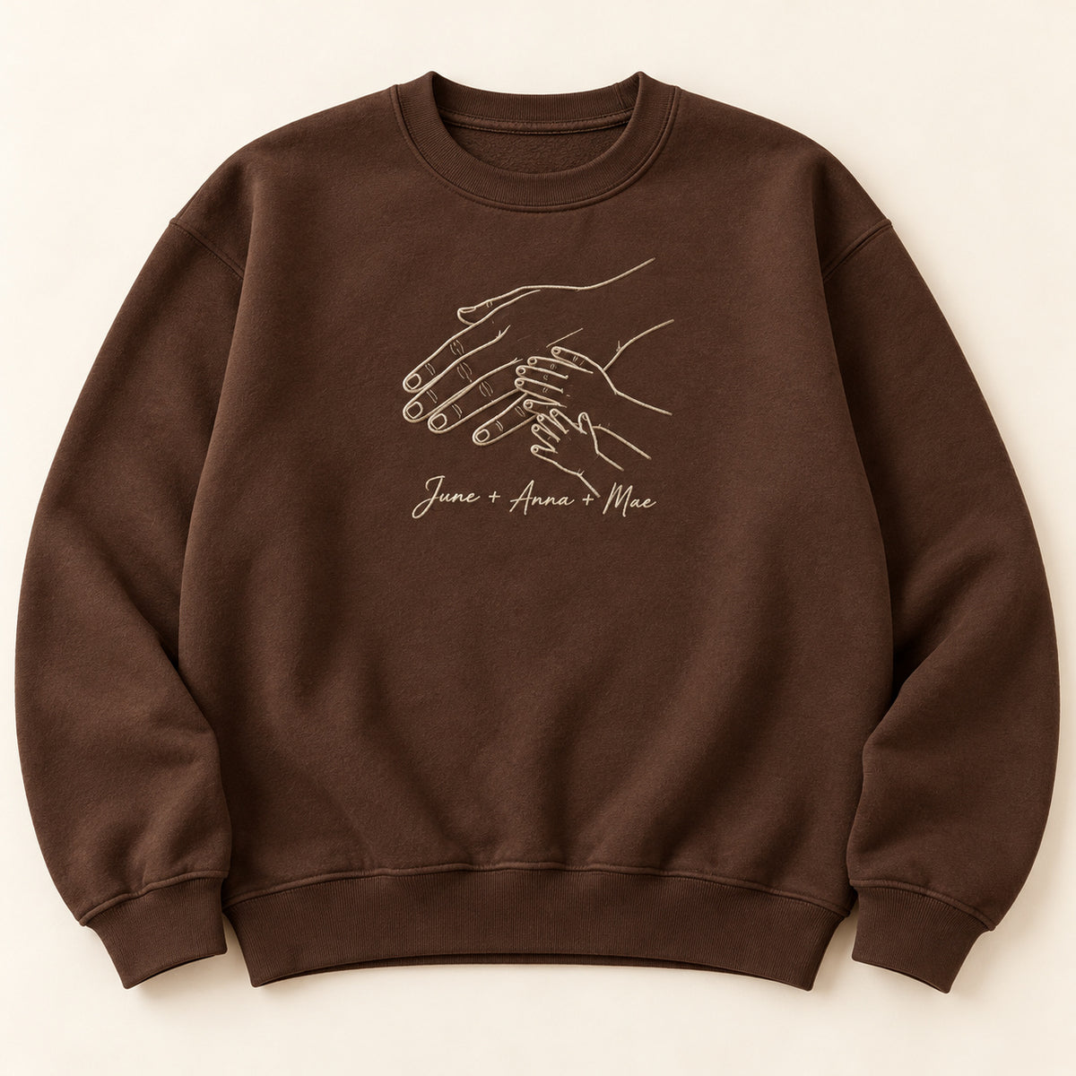 Love Across Generations personalized Family hands design; Chocolate sweatshirt mockup, hero; sample text June + Anna + Mae