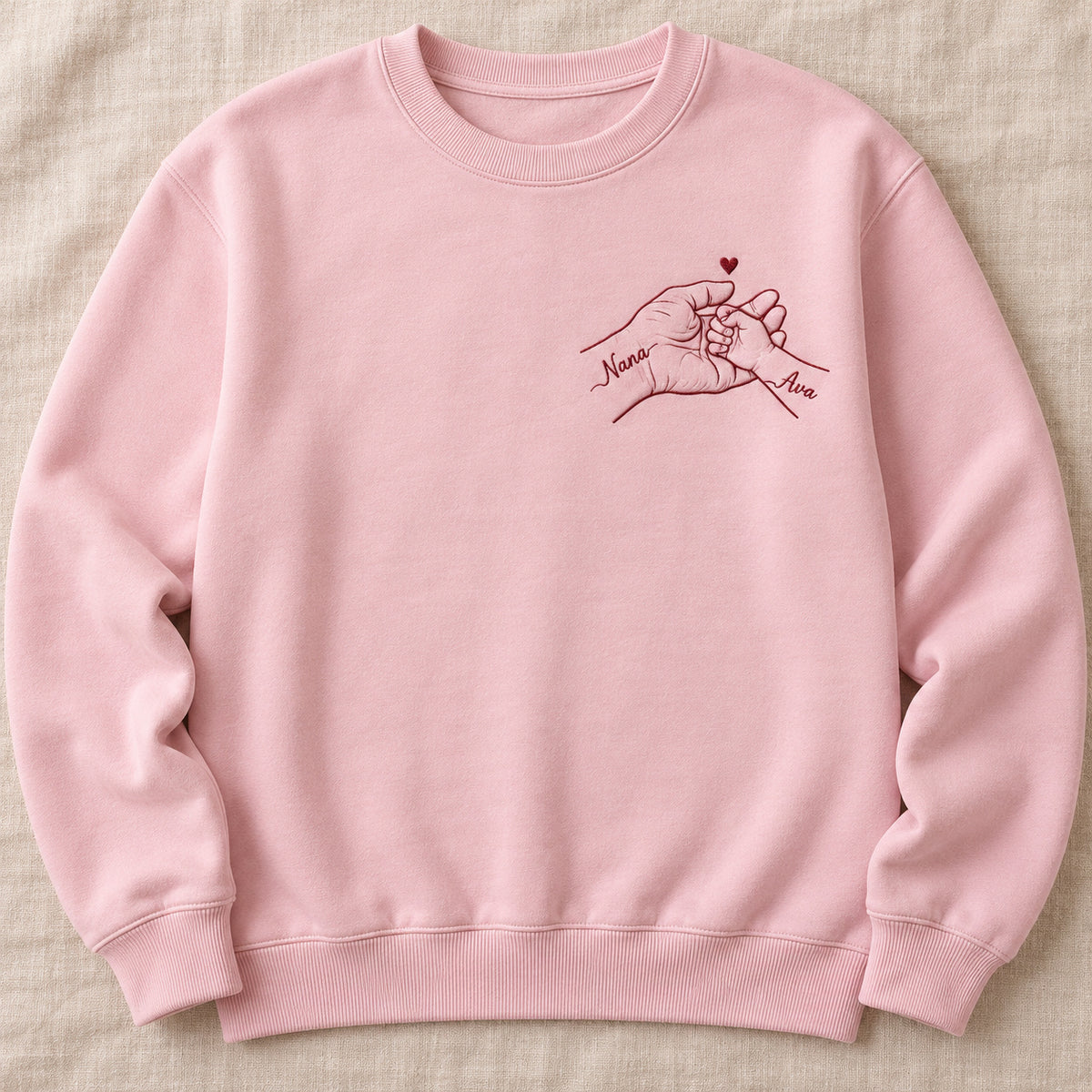 Held Through Life personalized Grandma hands design; Light Pink sweatshirt mockup, hero; sample text Nana / Ava