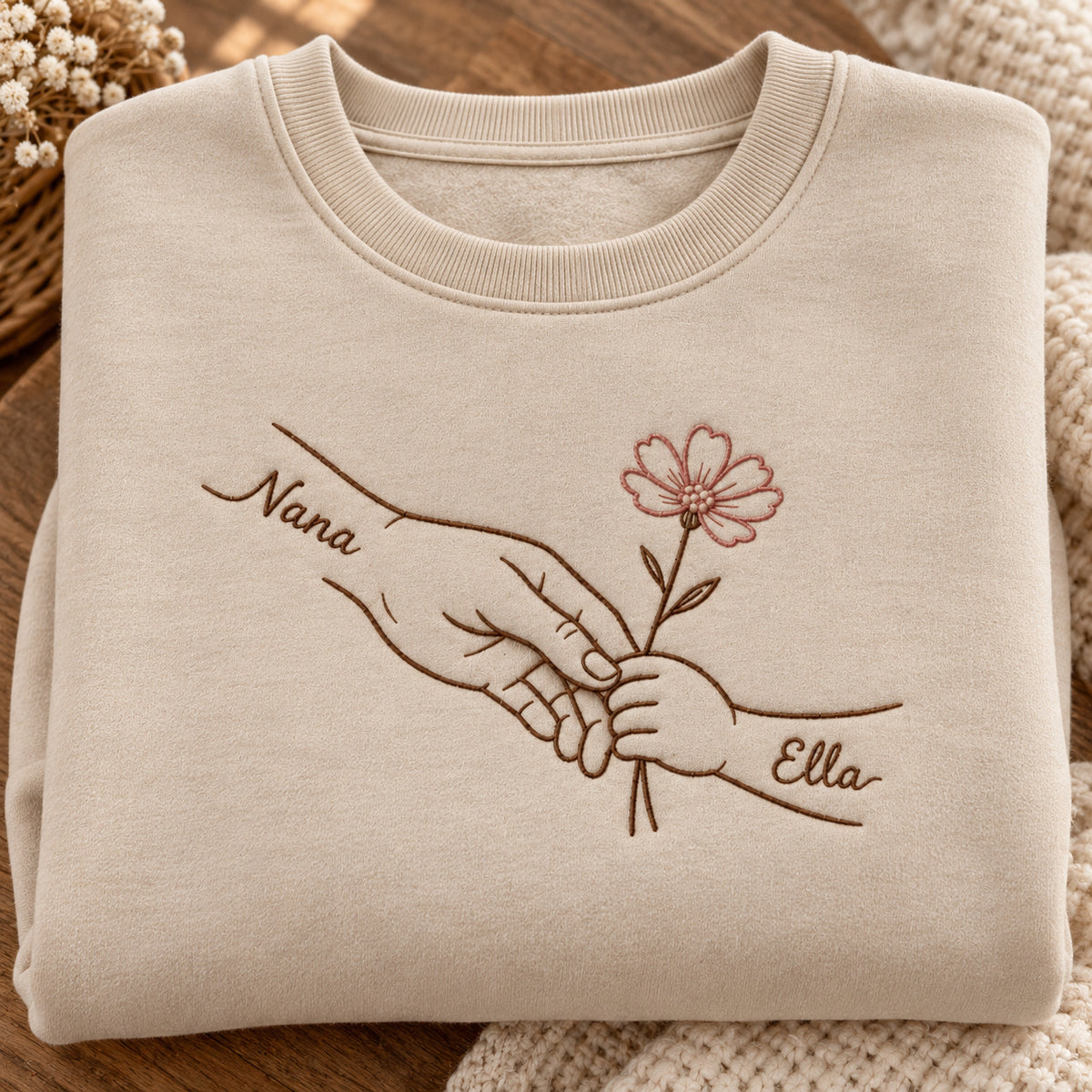 Teaching Gentle Hands personalized Grandma hands design; Beige sweatshirt mockup, personalization detail; sample text Nana / Ella