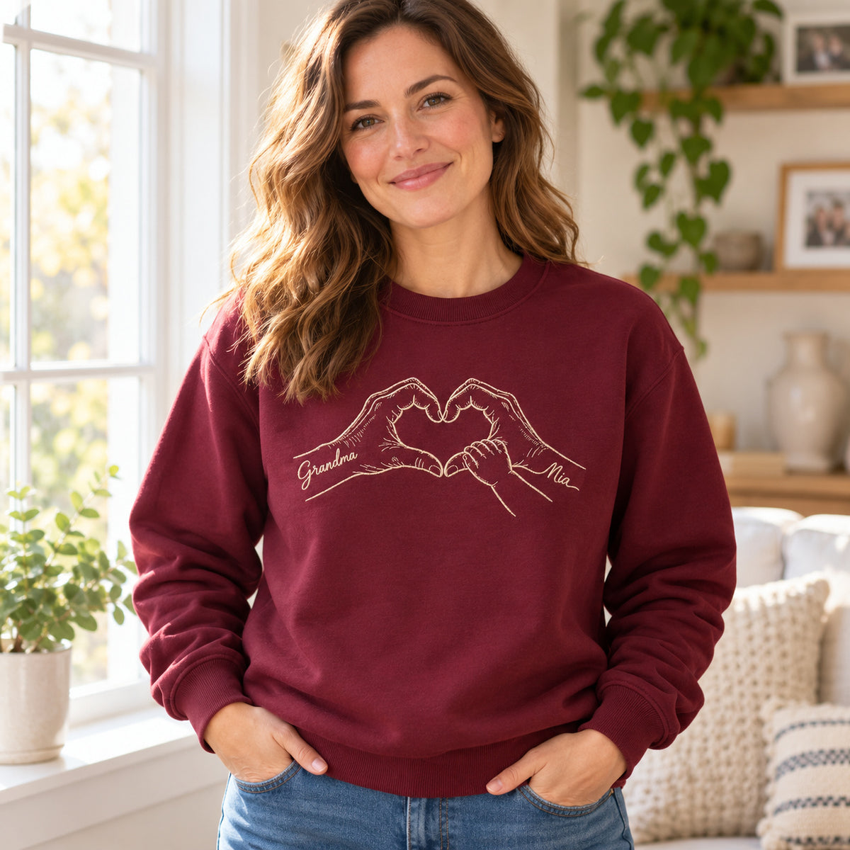 Heart of Grandma personalized Grandma hands design; Maroon sweatshirt mockup, lifestyle; sample text Grandma / Mia