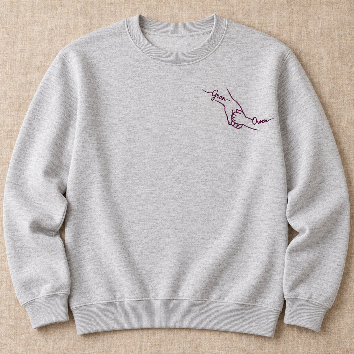 Little Hand Big Love personalized Grandma hands design; Ash sweatshirt mockup, hero; sample text Gran / Owen