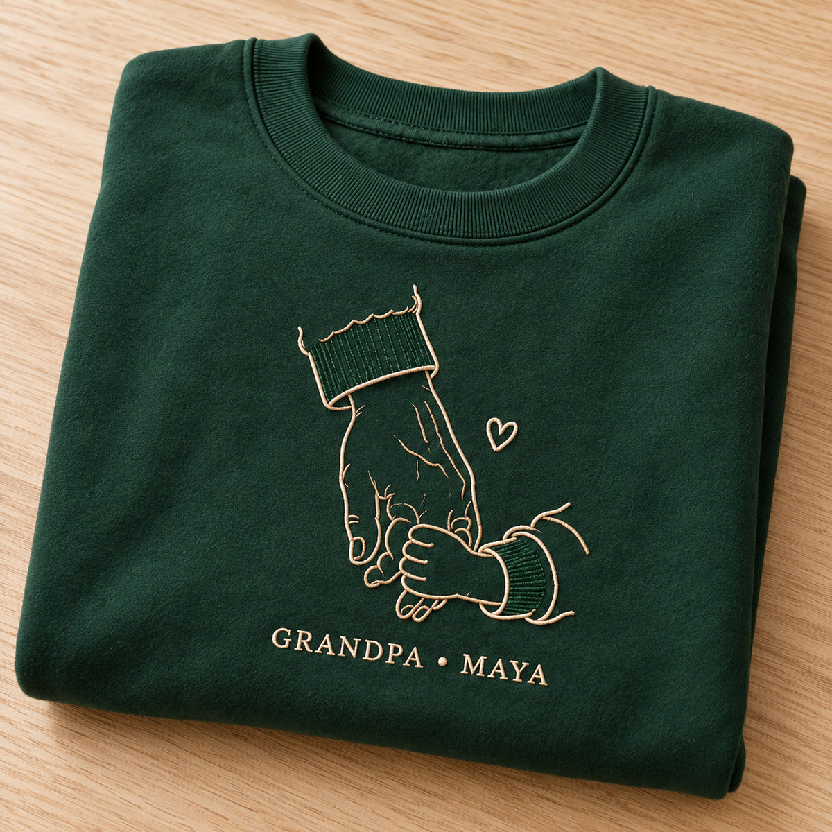 Always Beside You personalized Grandpa hands design; Forest Green sweatshirt mockup, personalization detail; sample text GRANDPA • MAYA