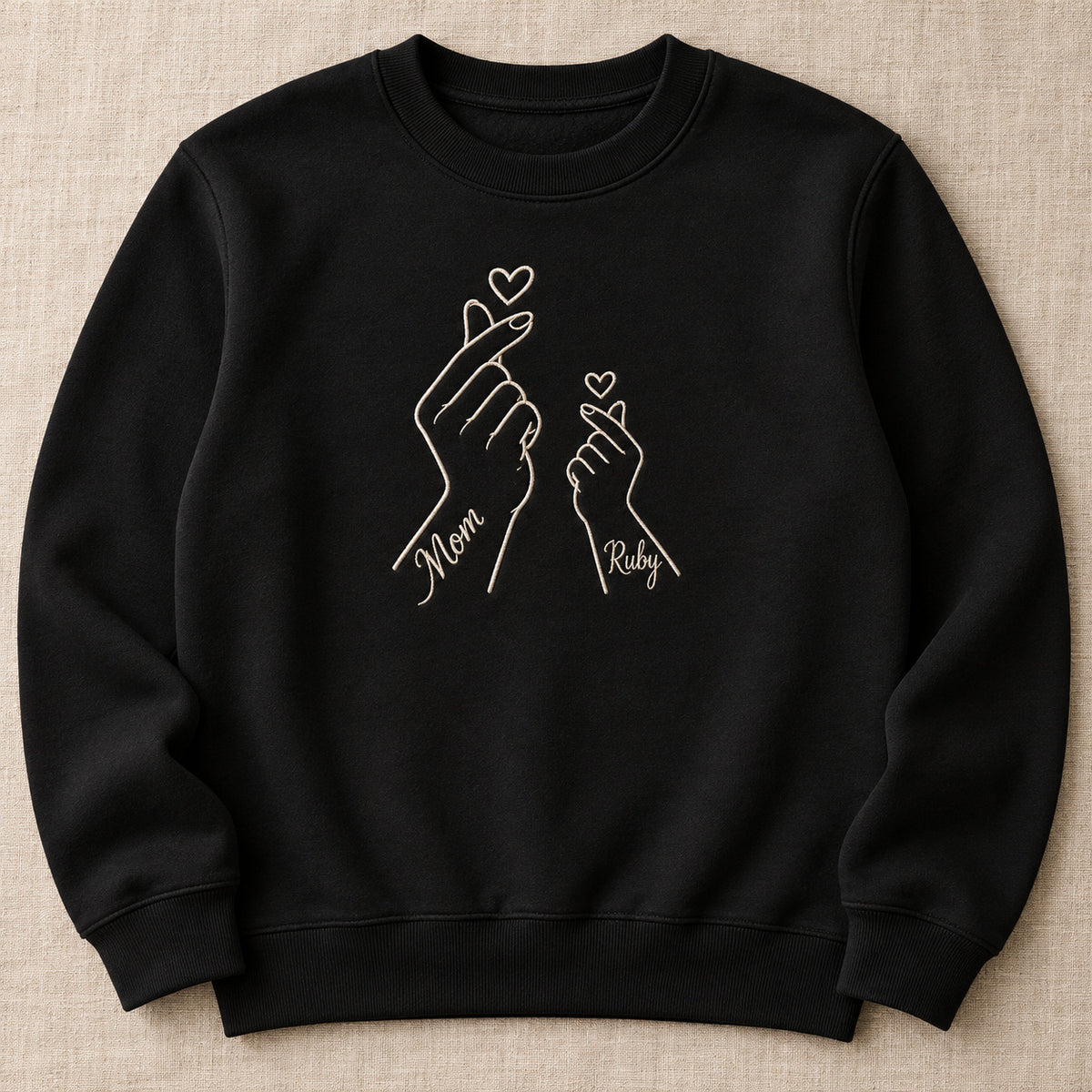Love Sign personalized Mom hands design; Black sweatshirt mockup, hero; sample text Mom / Ruby