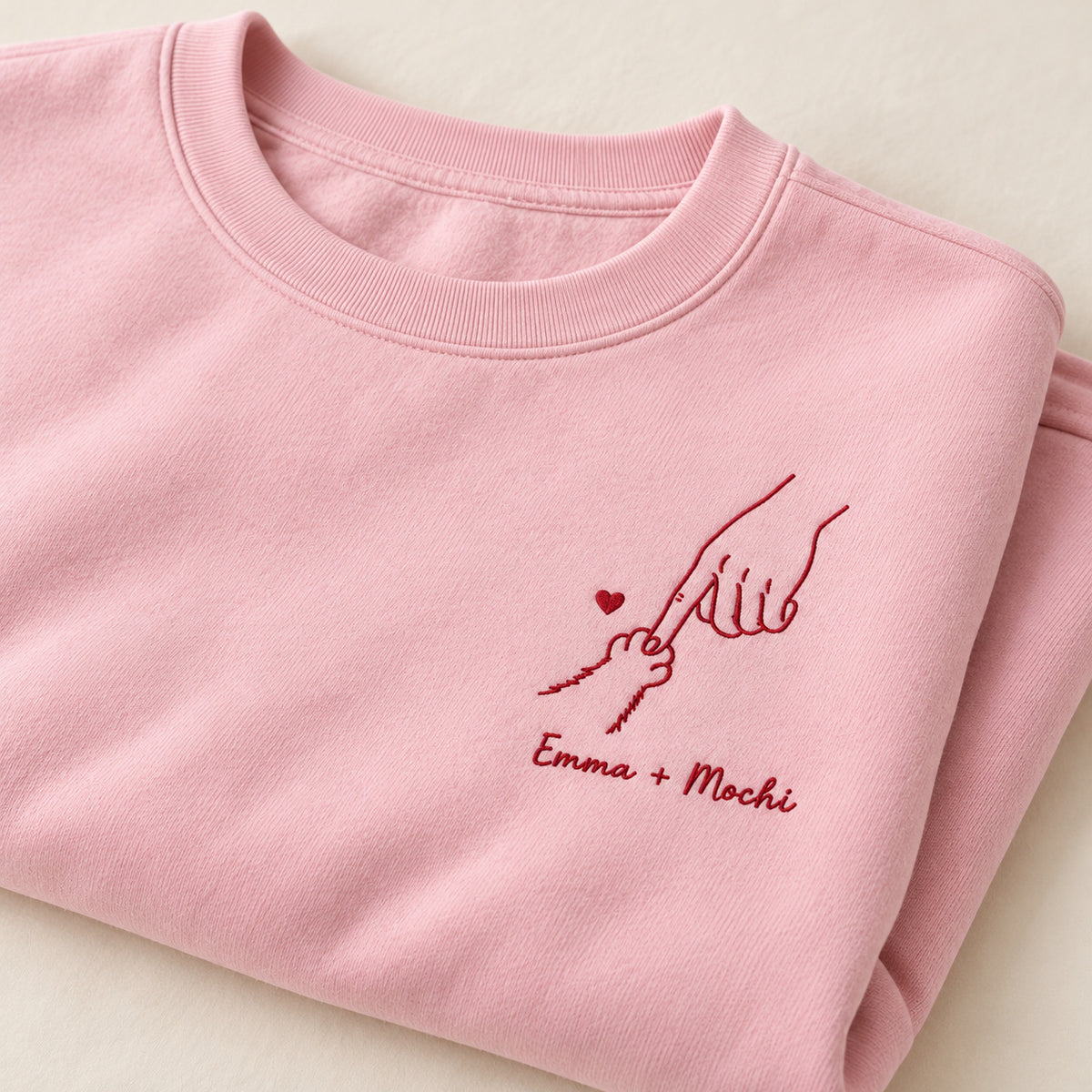 Little Paw Big Love personalized Pet_Lover hands design; Light Pink sweatshirt mockup, personalization detail; sample text Emma + Mochi