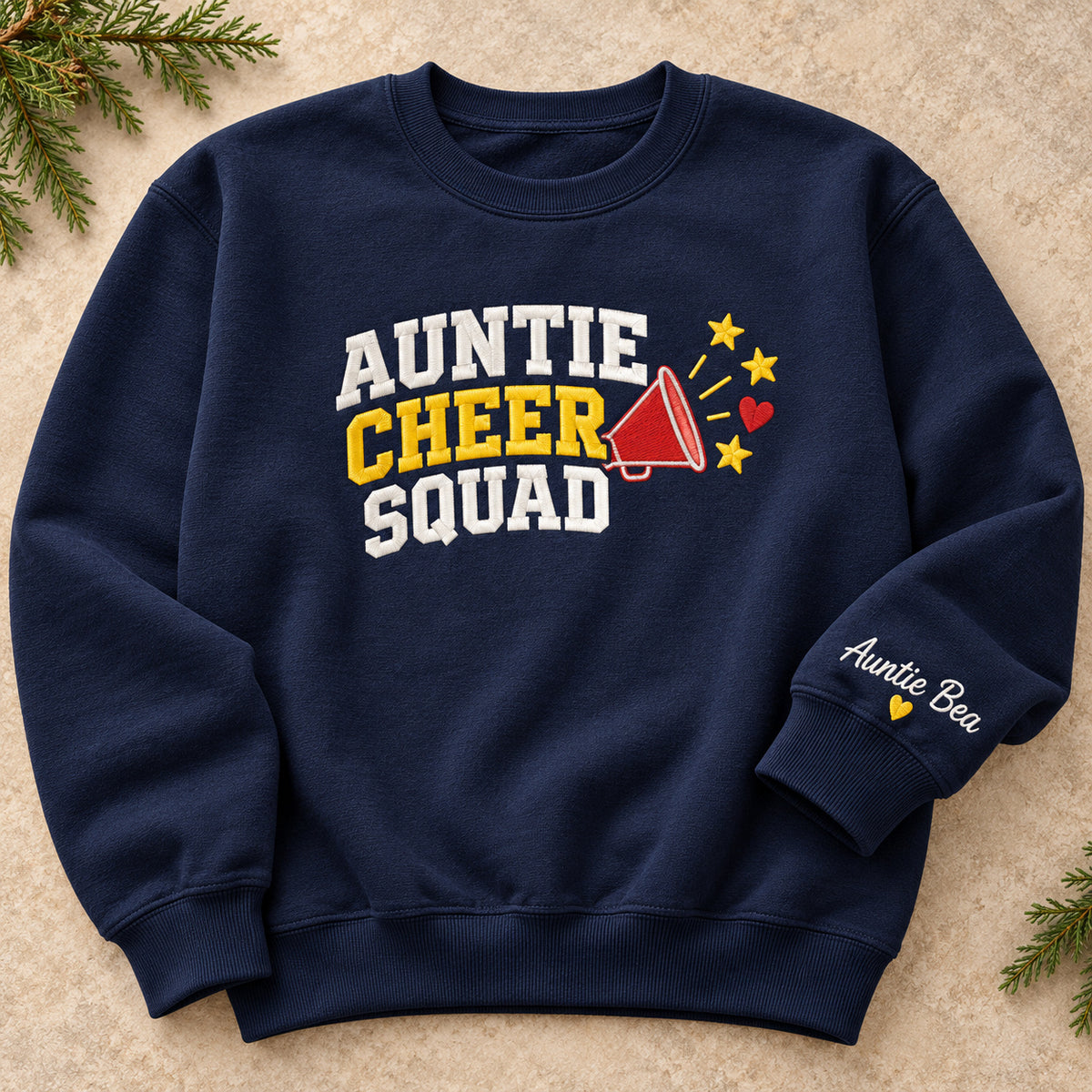 Auntie Cheer Squad sweatshirt concept mockup featuring a megaphone, stars and a small heart beside cheer lettering, sample personalization Auntie Bea, hero view