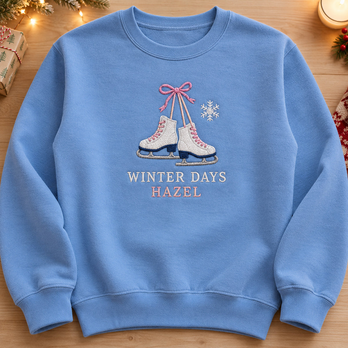 Winter Ice Skates sweatshirt concept mockup featuring a pair of ice skates tied with a pink bow, sample personalization HAZEL, hero view