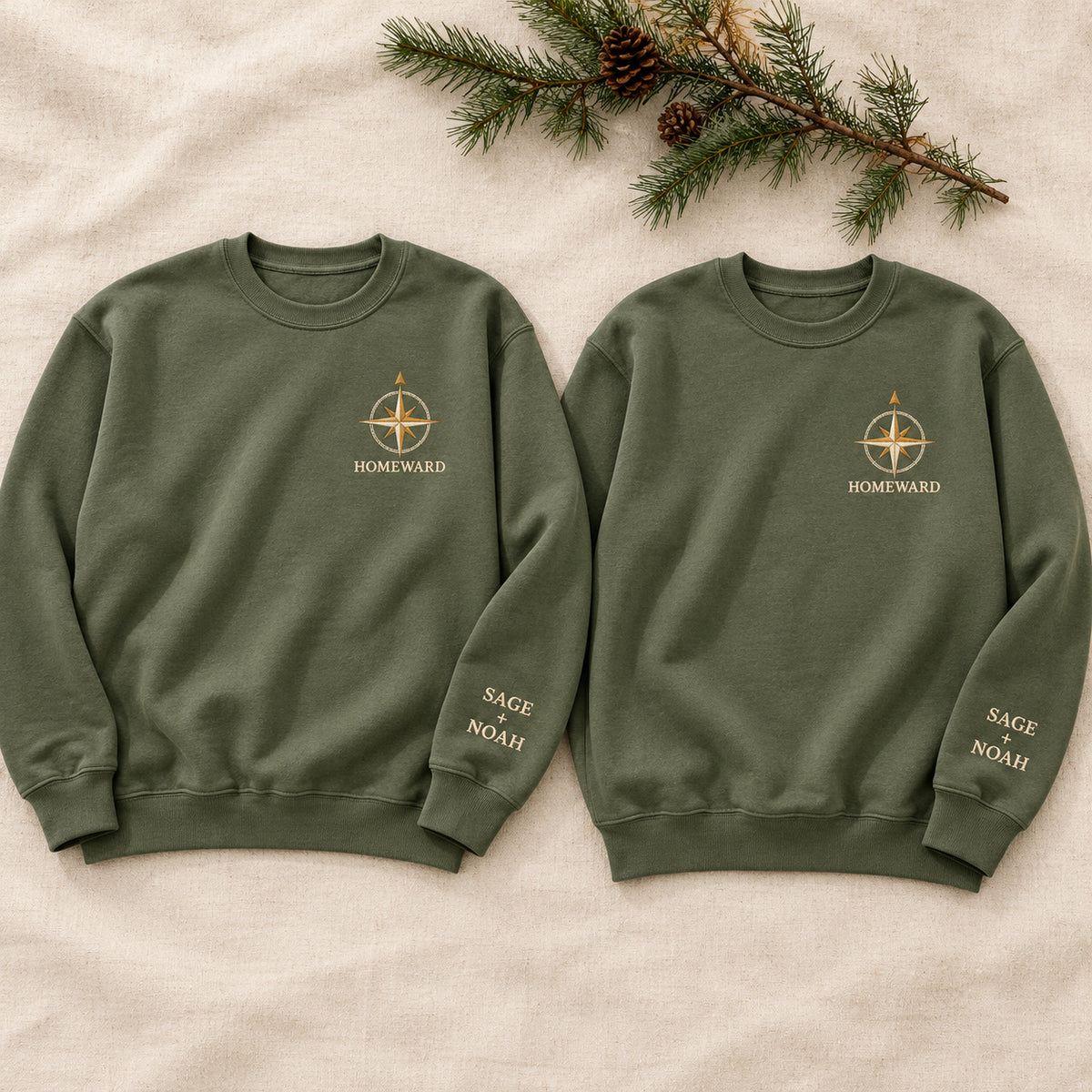 Homeward Compass sweatshirt concept mockup featuring a compass rose above HOMEWARD lettering, sample personalization SAGE + NOAH, hero view