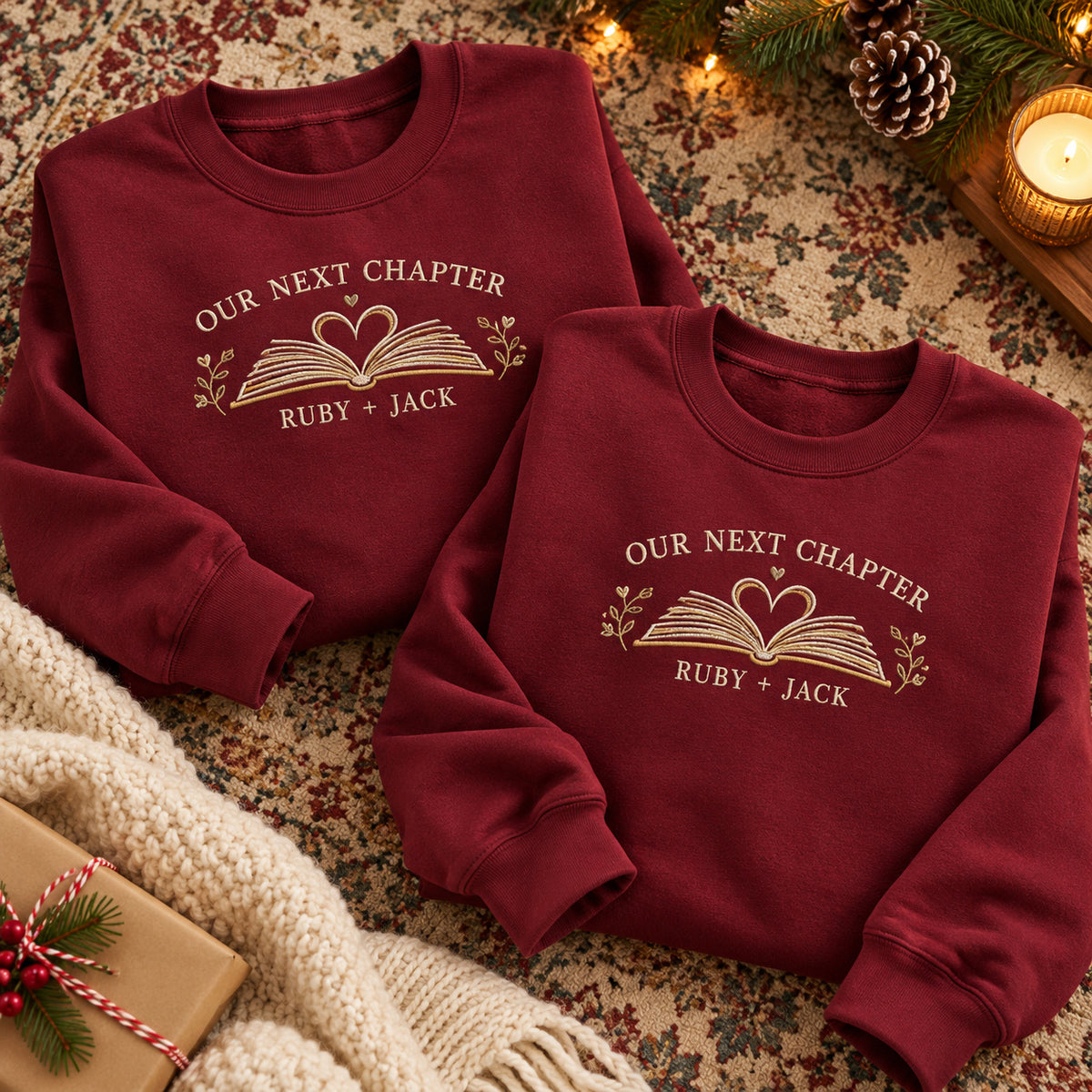 Our Next Chapter sweatshirt concept mockup featuring an open book with a heart and leafy accents, sample personalization RUBY + JACK, hero view