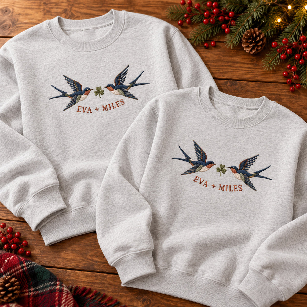 Returning Swallows sweatshirt concept mockup featuring two returning swallows with a leafy sprig, sample personalization EVA + MILES, hero view