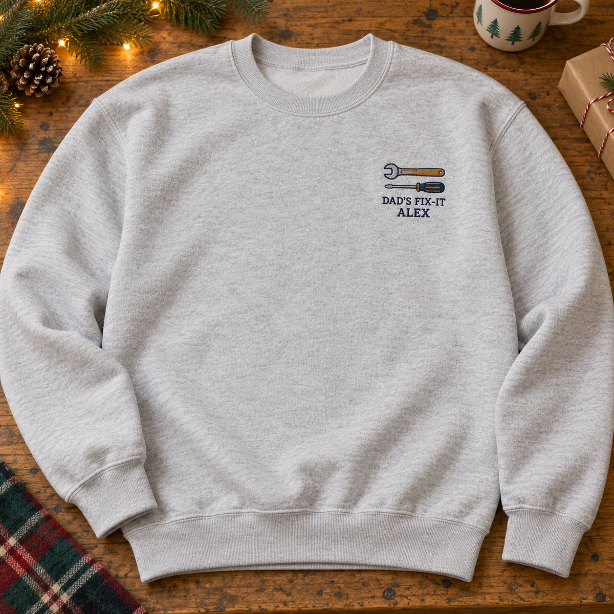 Dad's Fix-It sweatshirt concept mockup featuring a wrench and screwdriver, sample personalization ALEX, hero view