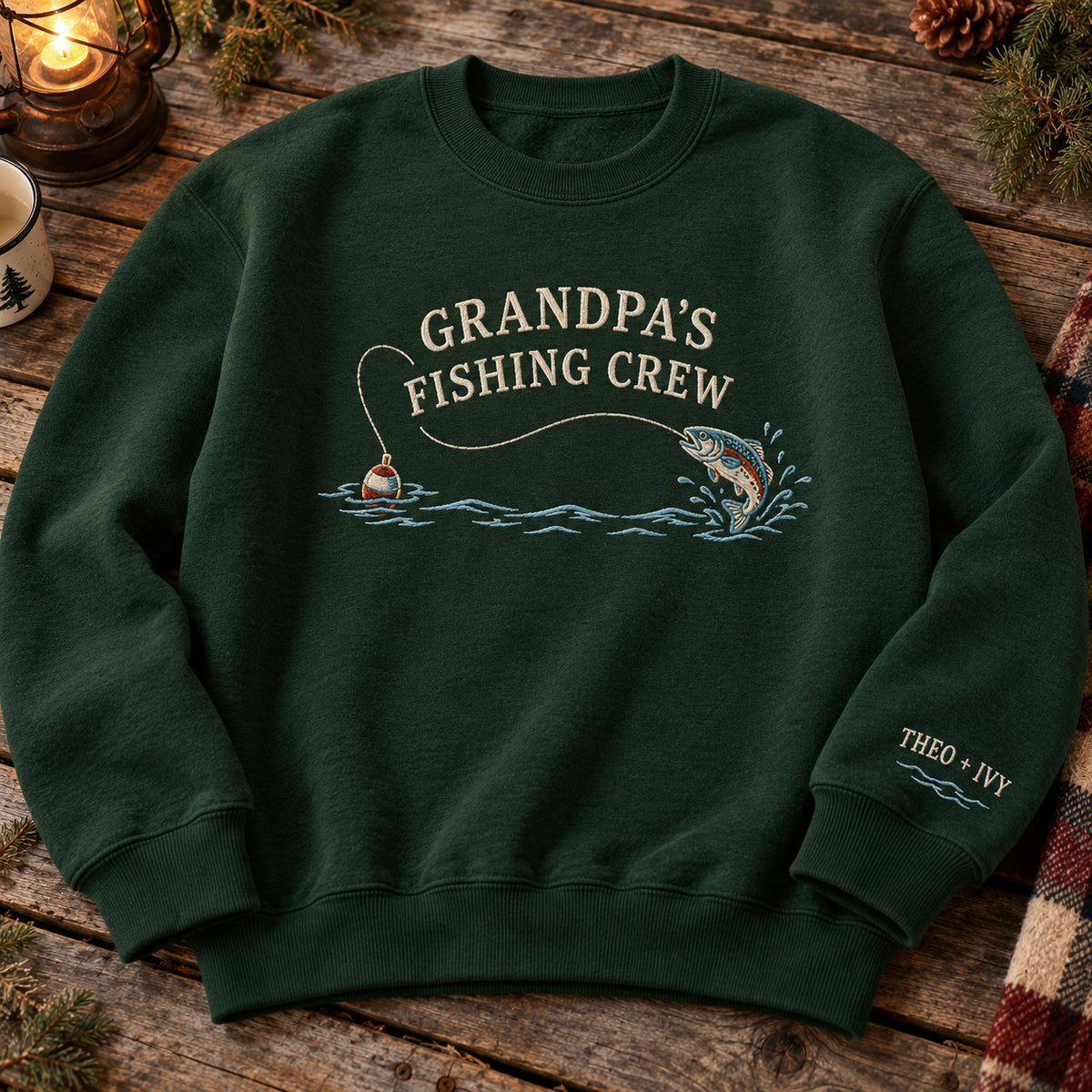 Grandpa's Fishing Crew sweatshirt concept mockup featuring a jumping fish, fishing float and flowing water, sample personalization THEO + IVY, hero view