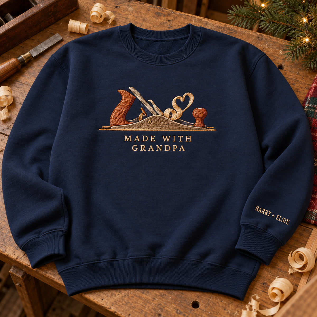 Made with Grandpa Woodwork sweatshirt concept mockup featuring a woodworking hand plane with curling wood shavings, sample personalization HARRY + ELSIE, hero view