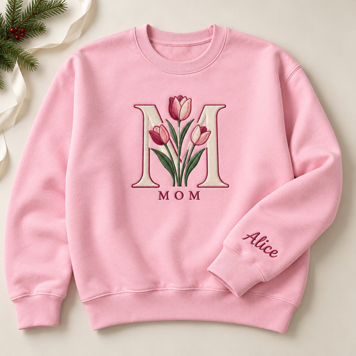 Mom's Tulip sweatshirt concept mockup featuring tulips framed by a large letter M, sample personalization Alice, hero view