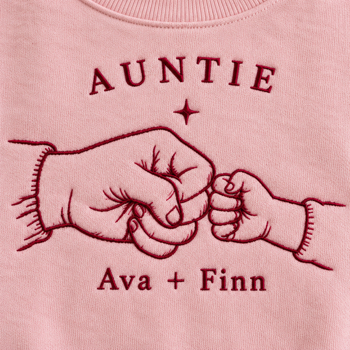 First Fist Bump personalized Auntie hands design; Light Pink sweatshirt mockup, embroidery detail; sample text AUNTIE / Ava + Finn