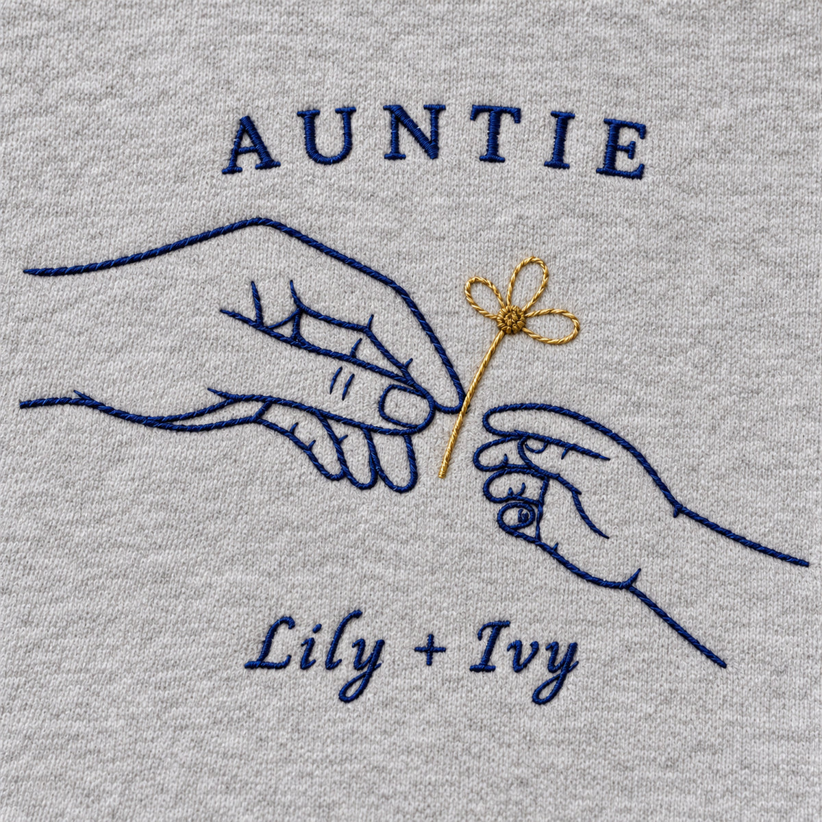 Gift of Daisies personalized Auntie hands design; Ash sweatshirt mockup, embroidery detail; sample text AUNTIE / Lily + Ivy