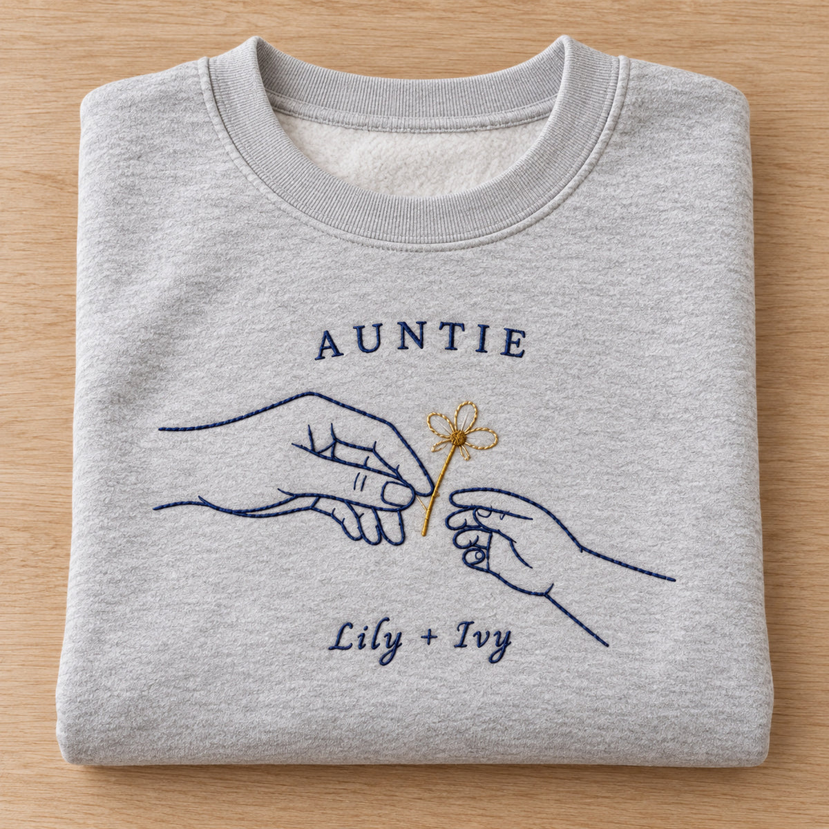 Gift of Daisies personalized Auntie hands design; Ash sweatshirt mockup, personalization detail; sample text AUNTIE / Lily + Ivy