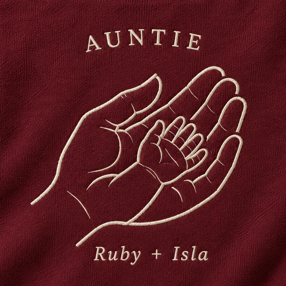 Handful of Love personalized Auntie hands design; Maroon sweatshirt mockup, embroidery detail; sample text AUNTIE / Ruby + Isla