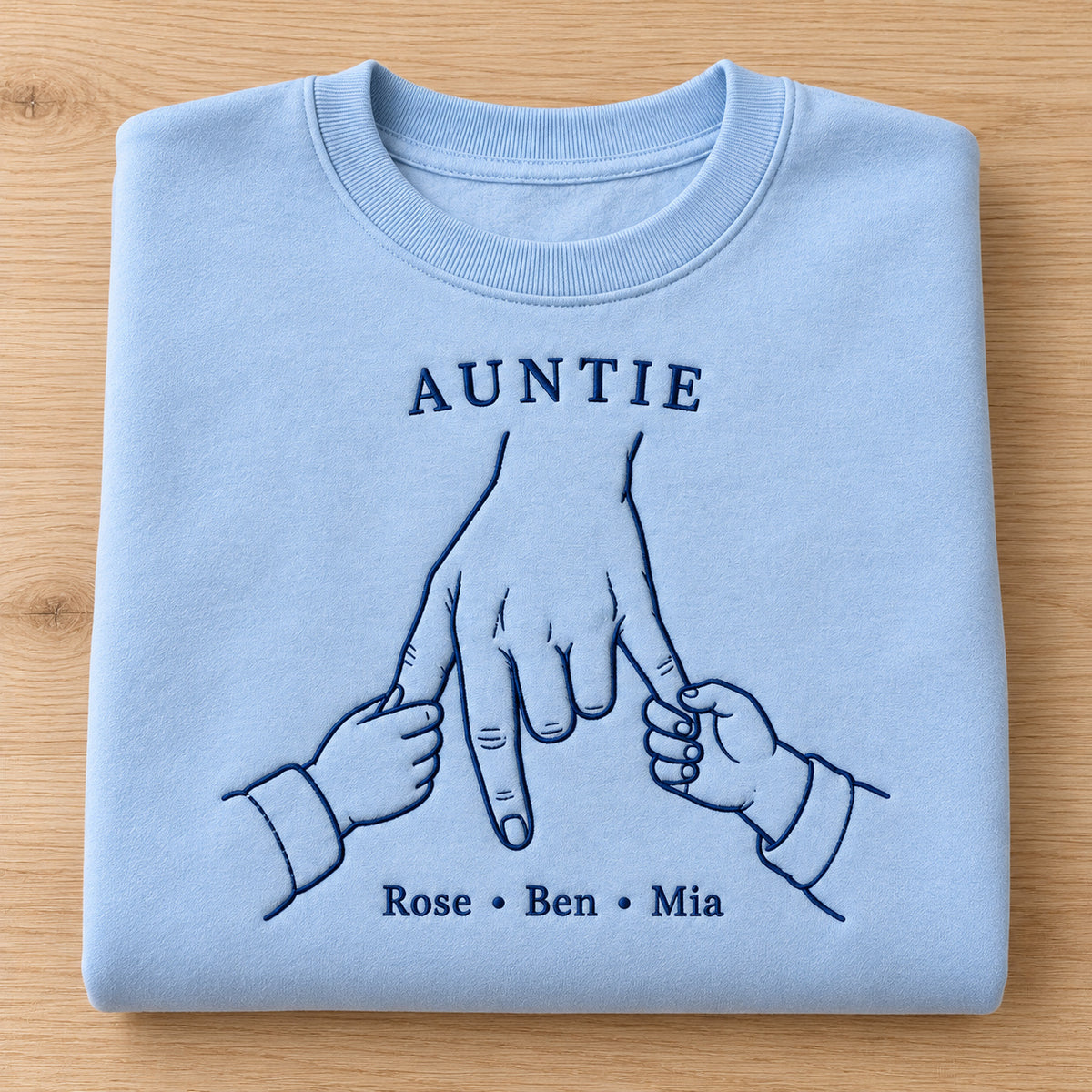 Double Little Hold personalized Auntie hands design; Light Blue sweatshirt mockup, personalization detail; sample text AUNTIE / Rose • Ben • Mia