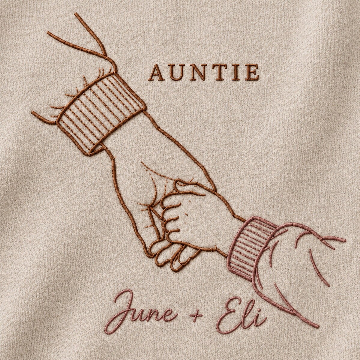 Walking Together personalized Auntie hands design; Beige sweatshirt mockup, embroidery detail; sample text AUNTIE / June + Eli