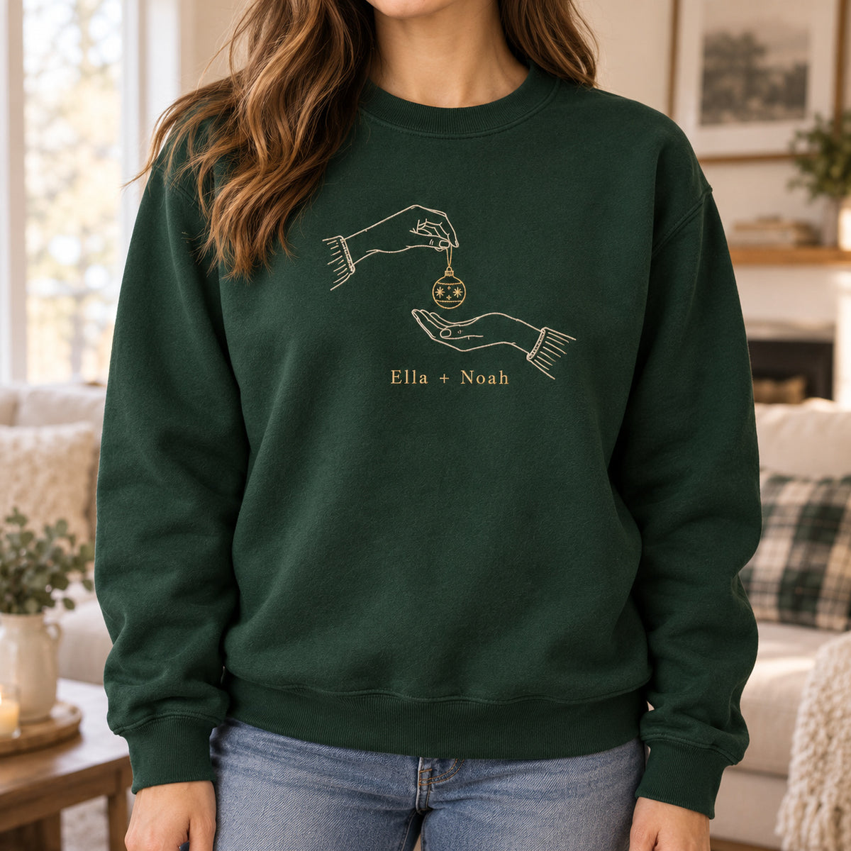 Ornament Exchange personalized Christmas hands design; Forest Green sweatshirt mockup, lifestyle; sample text Ella + Noah