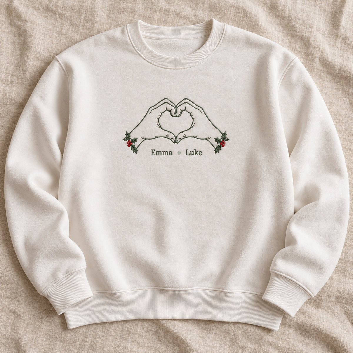 Christmas Heart Hands personalized Christmas hands design; White sweatshirt mockup, hero; sample text Emma + Luke