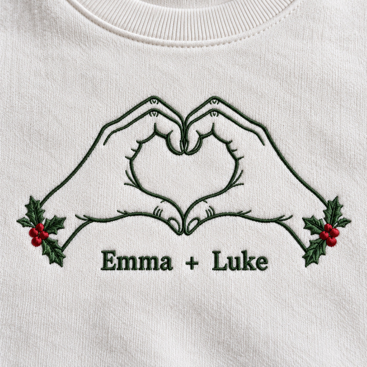 Christmas Heart Hands personalized Christmas hands design; White sweatshirt mockup, embroidery detail; sample text Emma + Luke