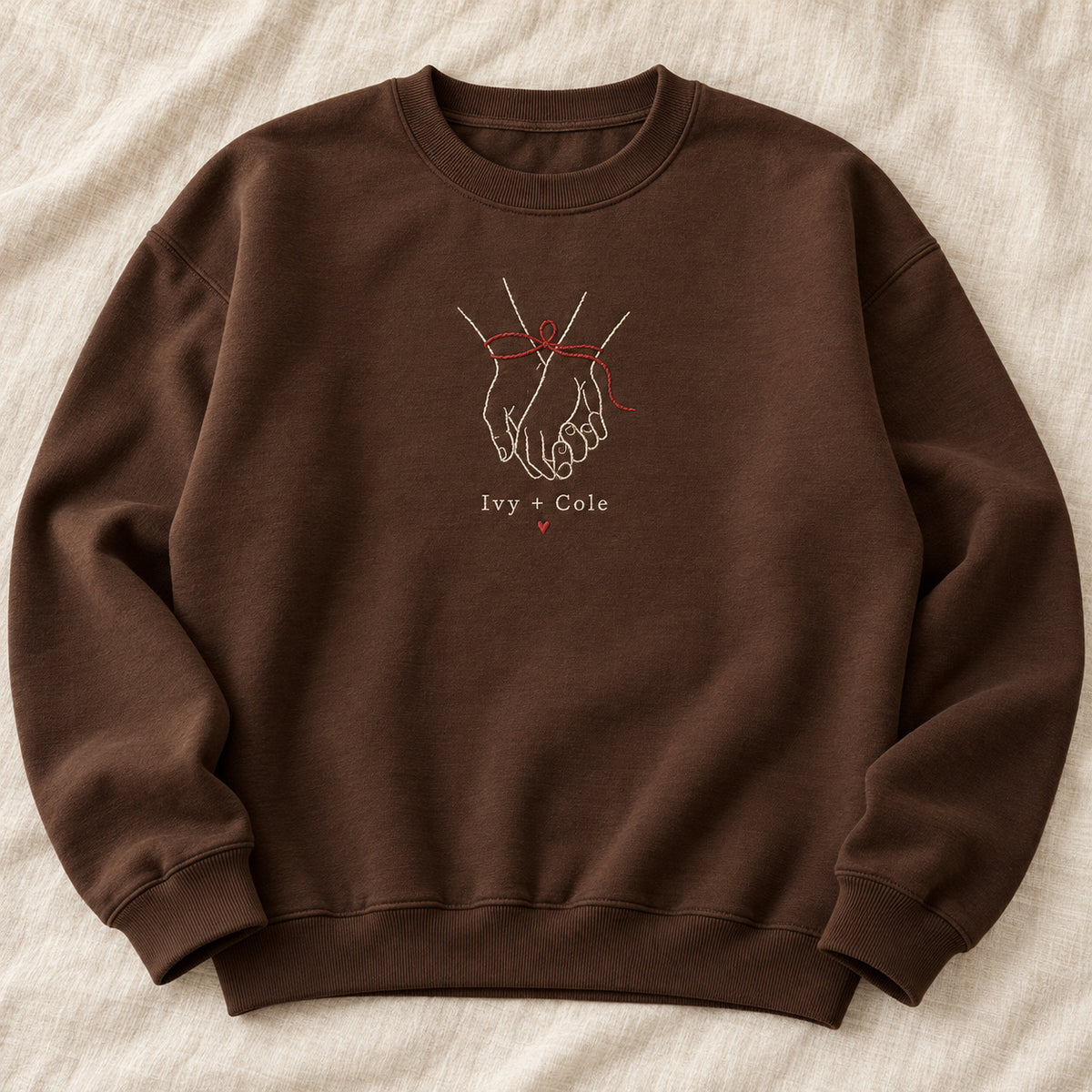 Ribbon Around Us personalized Christmas hands design; Chocolate sweatshirt mockup, hero; sample text Ivy + Cole