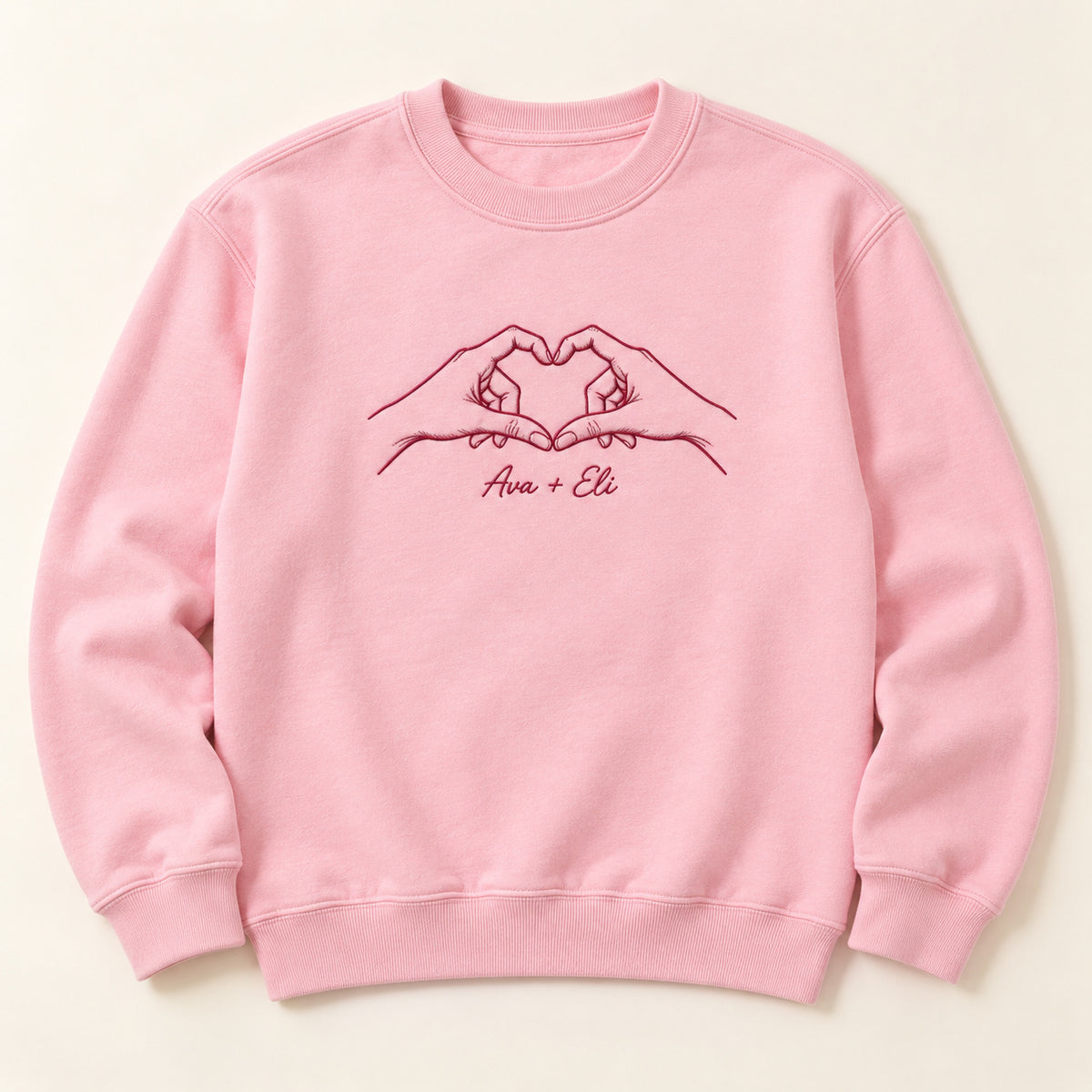 Heart Together personalized Couples hands design; Light Pink sweatshirt mockup, hero; sample text Ava + Eli