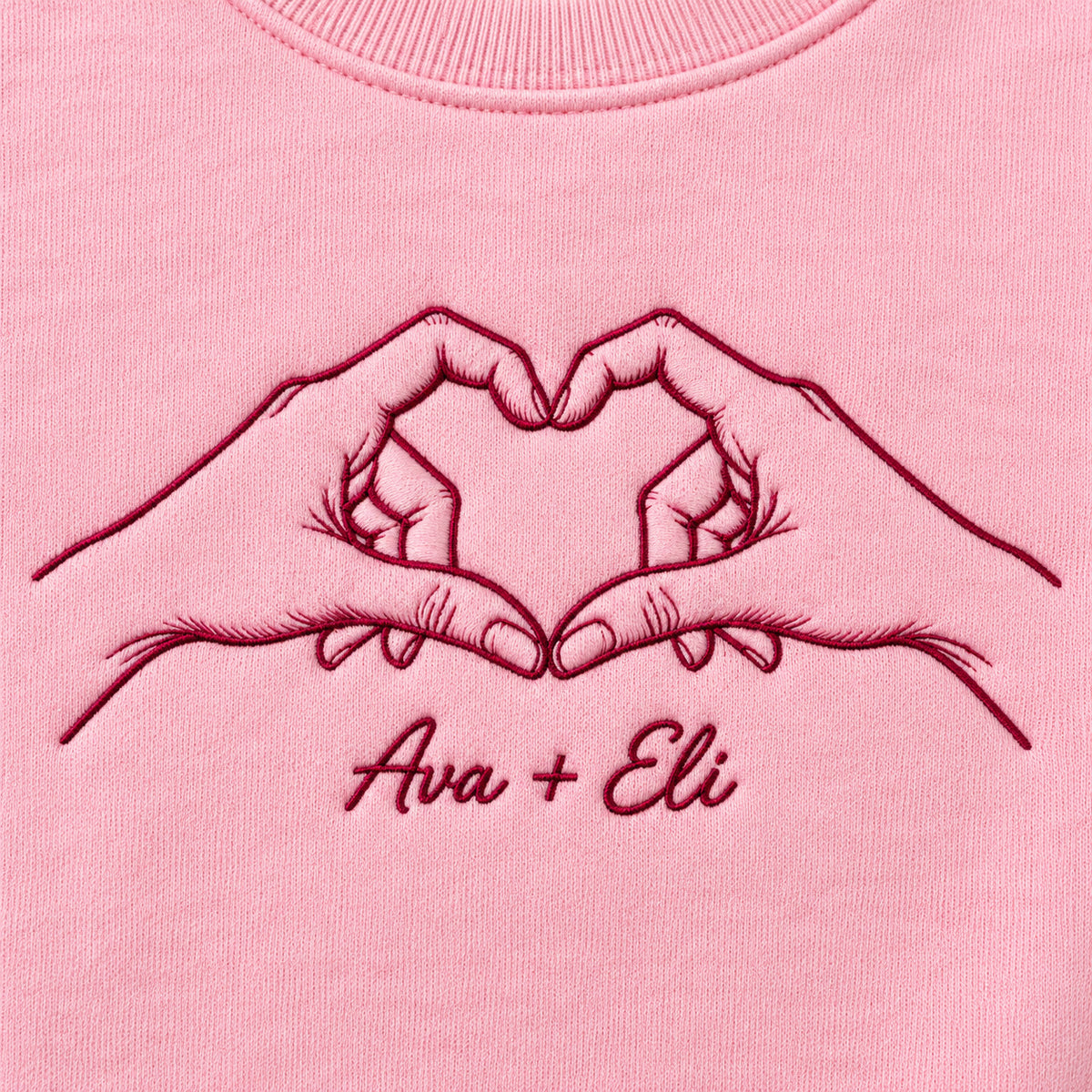 Heart Together personalized Couples hands design; Light Pink sweatshirt mockup, embroidery detail; sample text Ava + Eli