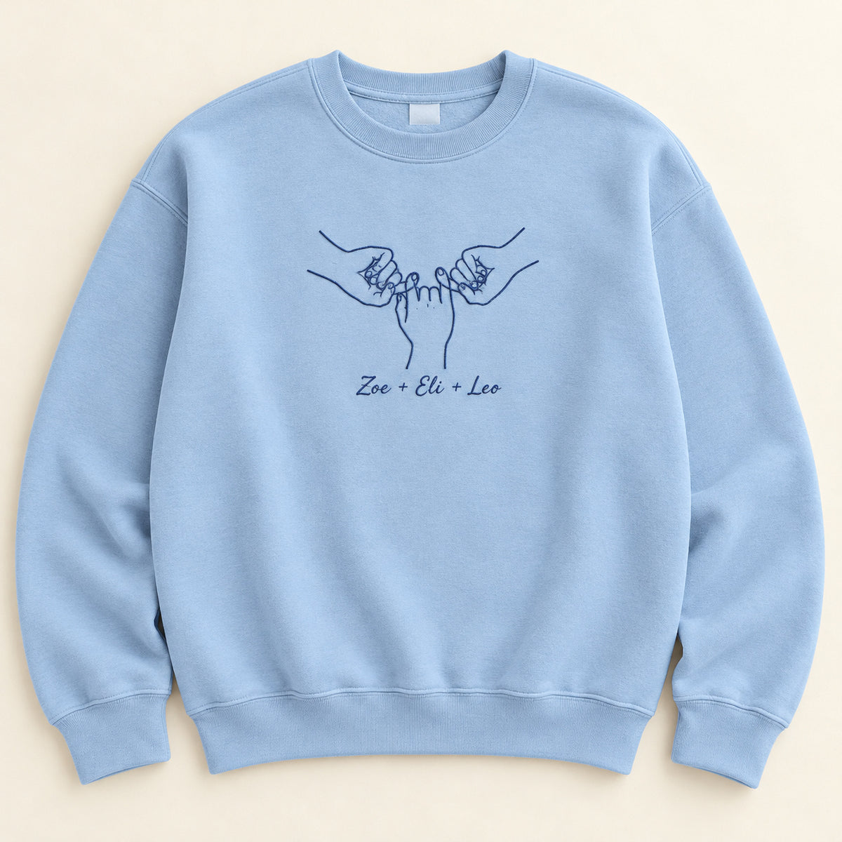 Our Promise personalized Family hands design; Light Blue sweatshirt mockup, hero; sample text Zoe + Eli + Leo