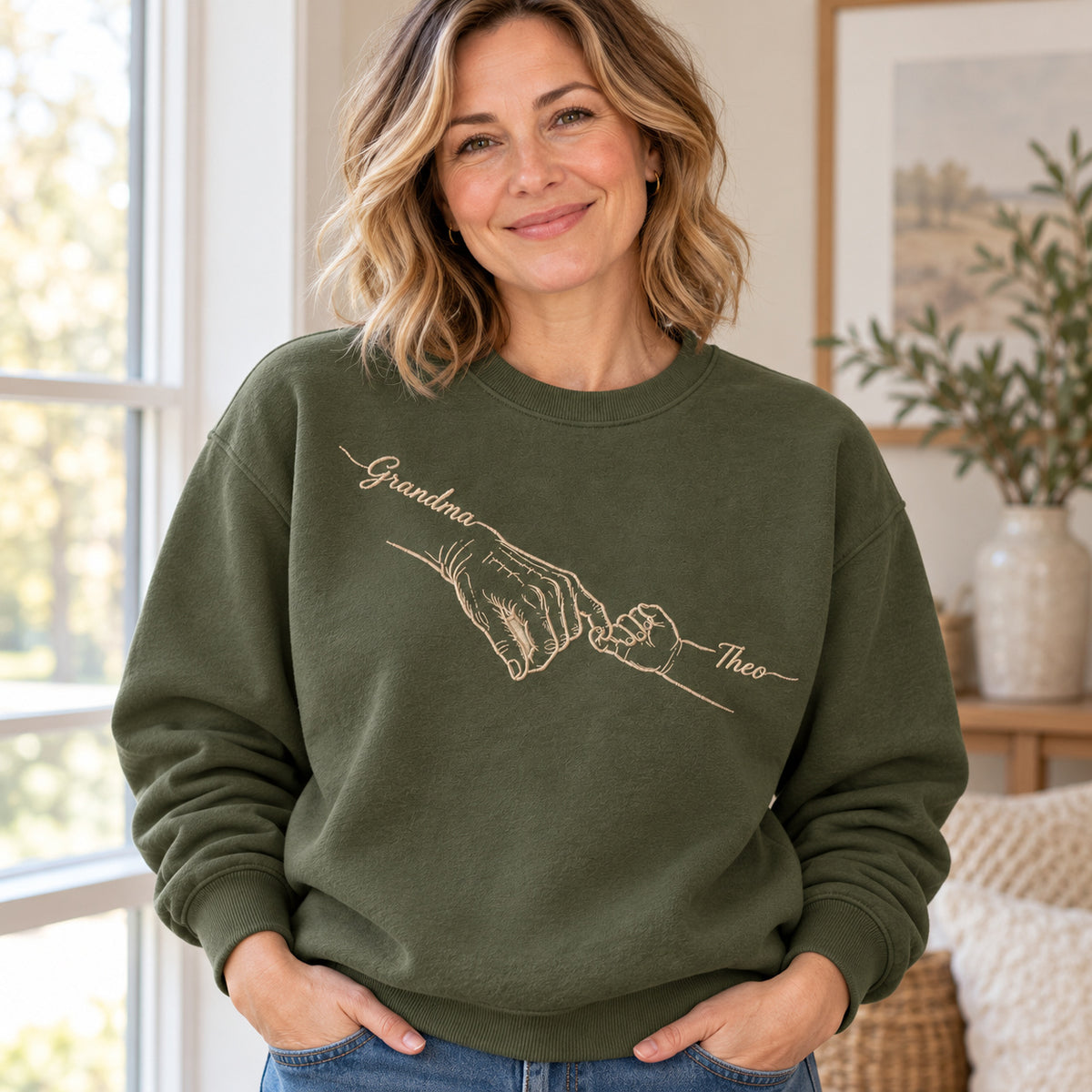 Grandma's Promise personalized Grandma hands design; Military Green sweatshirt mockup, lifestyle; sample text Grandma / Theo