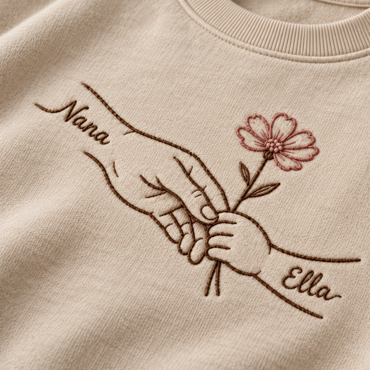 Teaching Gentle Hands personalized Grandma hands design; Beige sweatshirt mockup, embroidery detail; sample text Nana / Ella