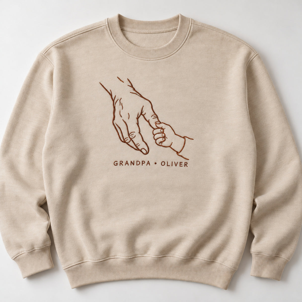 Generations Grip personalized Grandpa hands design; Sand sweatshirt mockup, hero; sample text GRANDPA • OLIVER