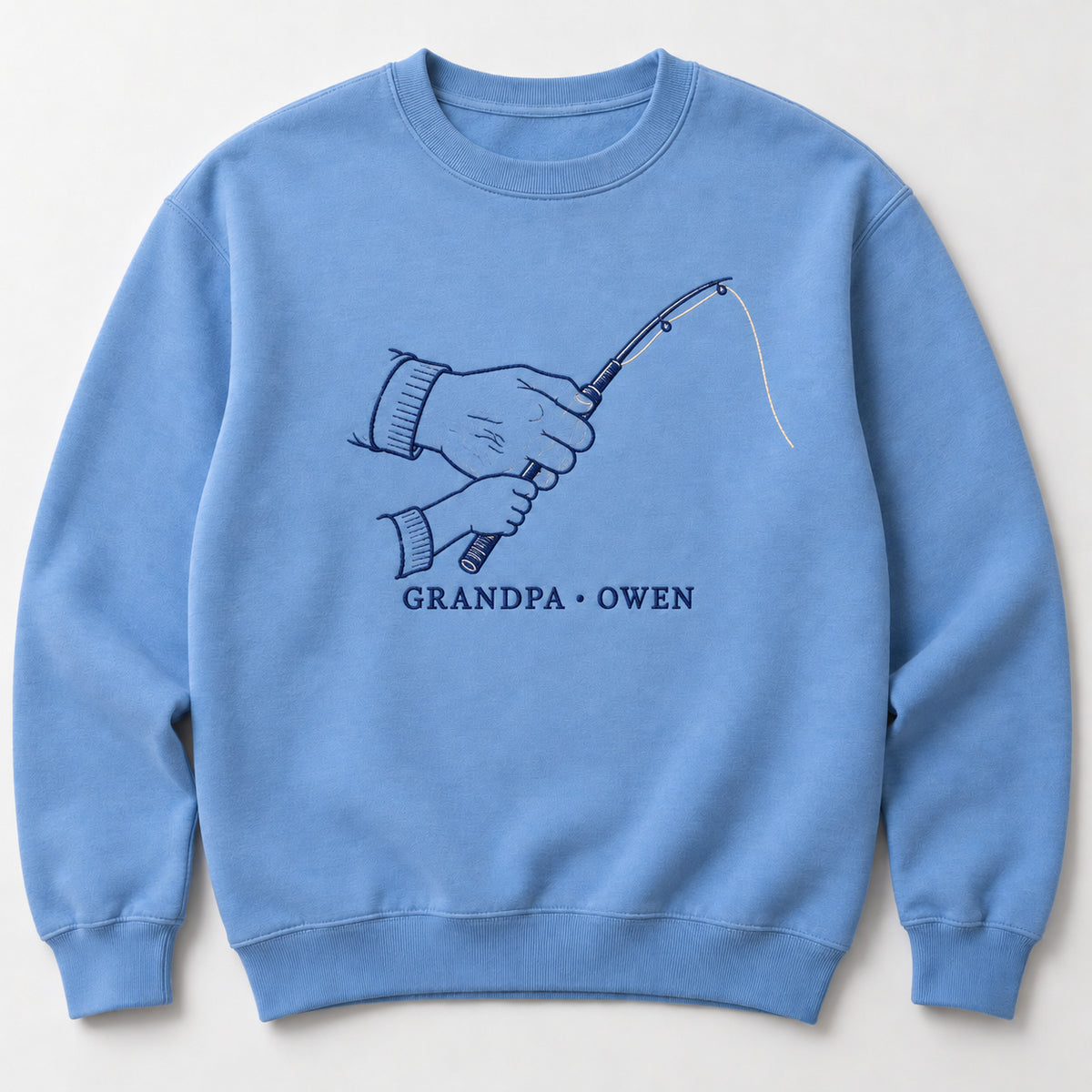 Fishing Memories personalized Grandpa hands design; Carolina Blue sweatshirt mockup, hero; sample text GRANDPA • OWEN