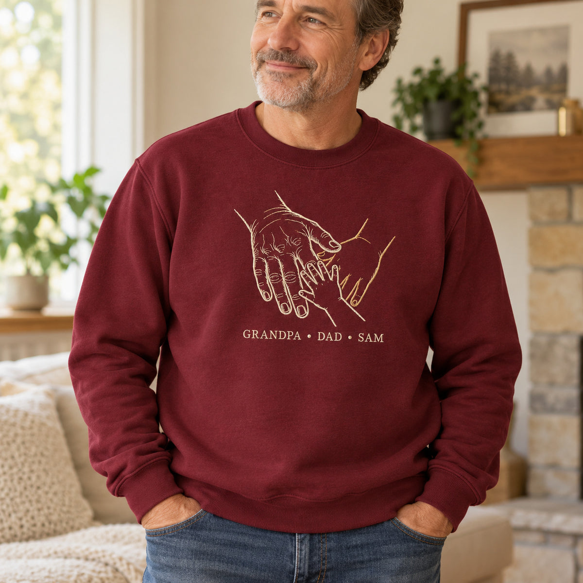 Three Generations personalized Grandpa hands design; Maroon sweatshirt mockup, lifestyle; sample text GRANDPA • DAD • SAM