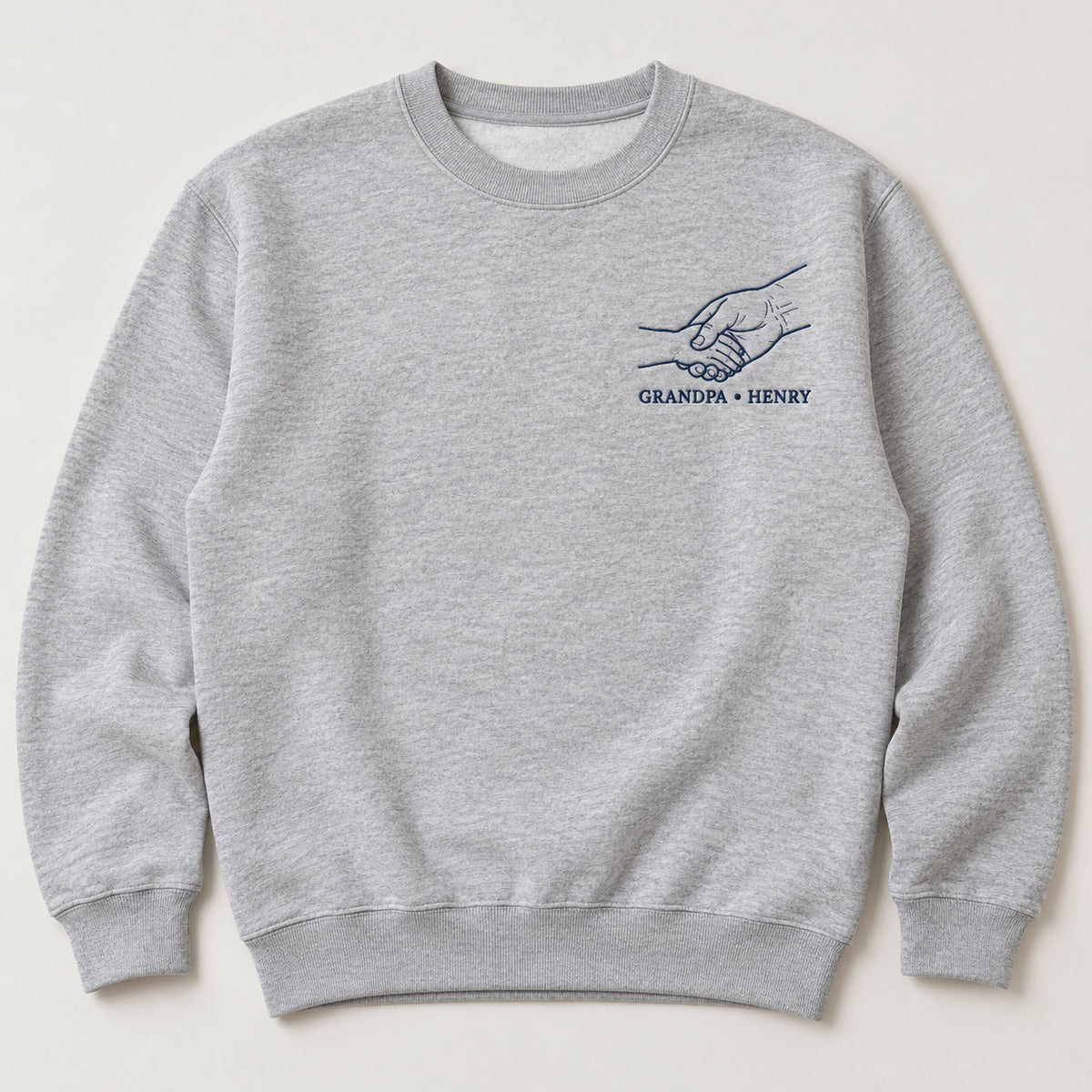 Grandpa Handshake personalized Grandpa hands design; Ash sweatshirt mockup, hero; sample text GRANDPA • HENRY