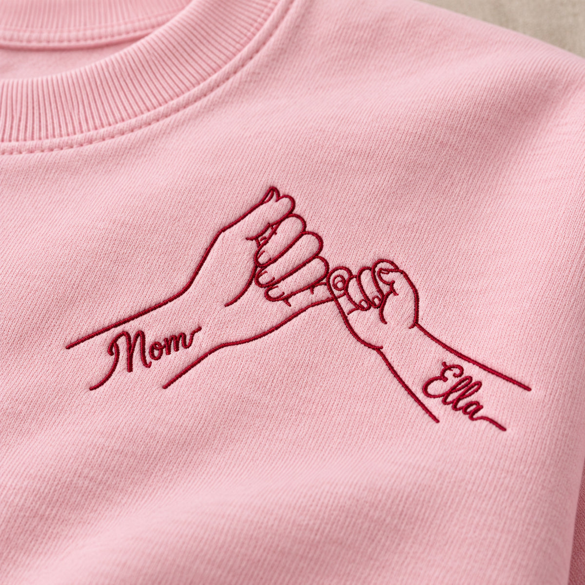 Pinky Promise personalized Mom hands design; Light Pink sweatshirt mockup, embroidery detail; sample text Mom / Ella