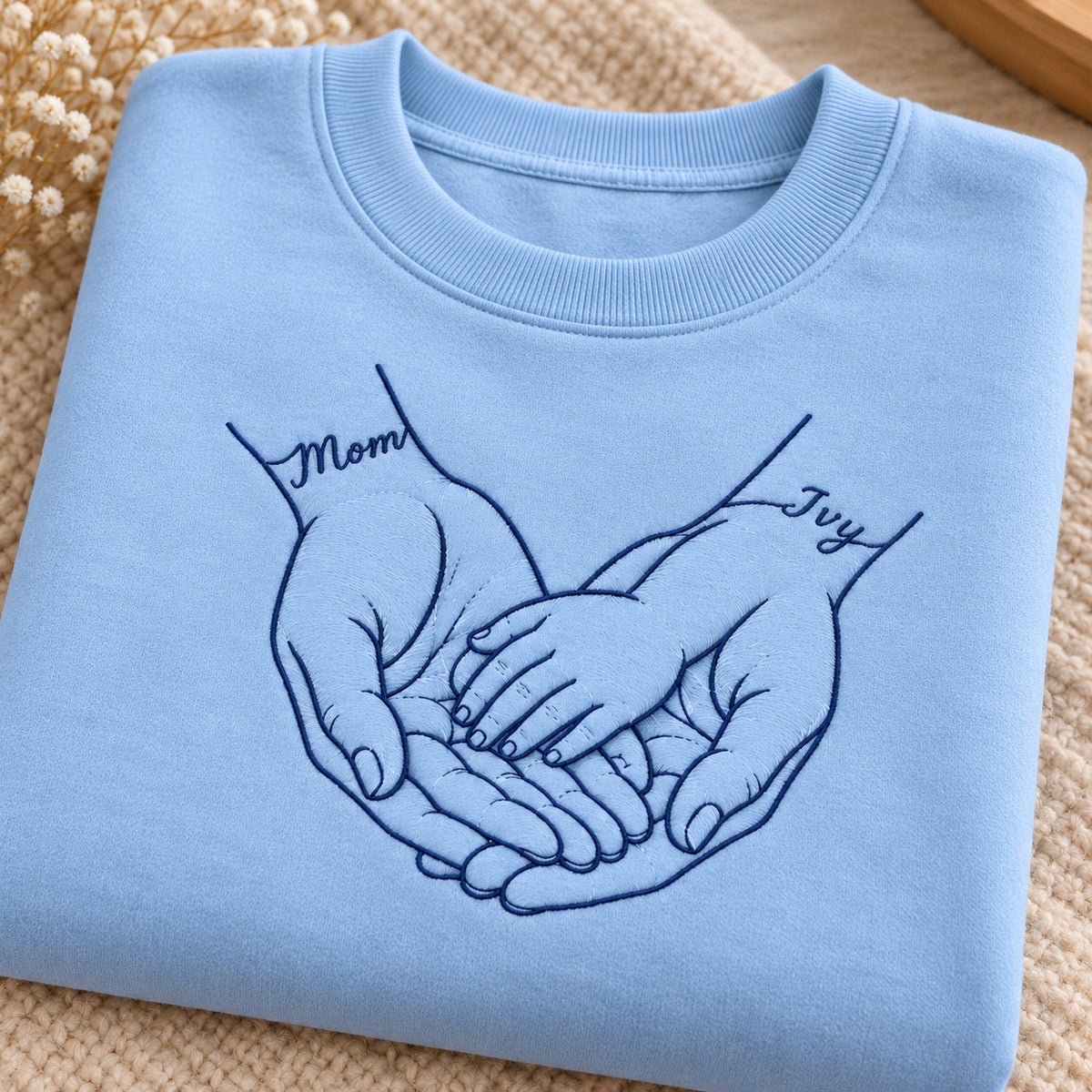 Safe in My Hands personalized Mom hands design; Light Blue sweatshirt mockup, personalization detail; sample text Mom / Ivy